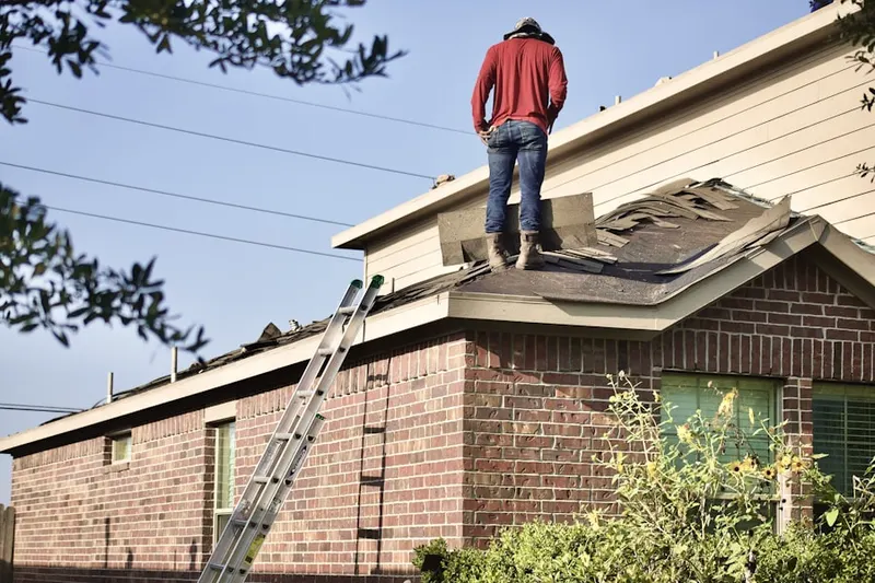 Professional roofer working on a residential roof in South Sanford Heights